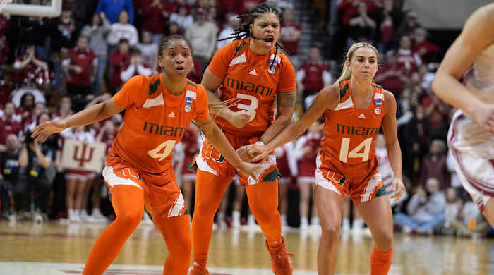 Miami’s Jasmyne Roberts, Destiny Harden and Haley Cavinder react after Harden hit a late shot to help the Hurricanes beat Indiana in the second round of the NCAA women’s tournament.